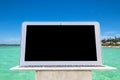 Laptop computer on wooden table. Top ocean view. Tropical island background. Open blank laptop computer empty space. Front view w Royalty Free Stock Photo