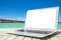 Laptop computer on wooden table. Top ocean view. Tropical island background. Open blank laptop computer empty space. Front view Royalty Free Stock Photo