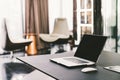 Laptop computer on work table in modern luxury contemporary office. Corporate business, internet information technology concept Royalty Free Stock Photo