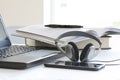 Laptop computer on working table with books, papers, pencil, headphones and smartphone. Close up stoc Royalty Free Stock Photo