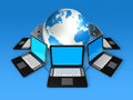 Laptop computers around a world globe Royalty Free Stock Photo