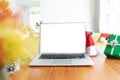 Laptop with copy space on screen lying on table with christmas decorations