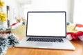 Laptop with copy space on screen lying on table with christmas decorations