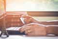 Laptop and credit card in girl`s hand on white table surface,selective focus.Business ,finance and online shoping concept