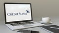 Laptop with Credit Suisse Group logo on the screen. Modern workplace conceptual editorial 3D rendering