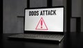 Laptop with DDOS attack warning on screen displaying alert sign featuring computer, Royalty Free Stock Photo