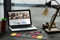 laptop with depositphotos website on table with macarons coffee and sale tags Royalty Free Stock Photo