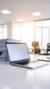 Laptop on desk in bright modern office environment with paperwork Royalty Free Stock Photo