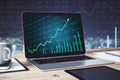 Laptop on desk with stock chart on screen Royalty Free Stock Photo