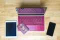 Laptop and digital device on wooden desk Royalty Free Stock Photo