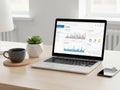 Laptop displaying analytics dashboard with charts and graphs on a desk Royalty Free Stock Photo