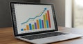 Laptop displaying a bar chart and line graph on its screen. The bar chart feature
