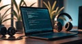 Programming laptop with headphones for software development and coding work station setup Royalty Free Stock Photo