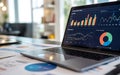 Data analysis and financial report displayed on laptop screen in a modern office setting. Royalty Free Stock Photo
