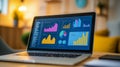 Laptop displaying colorful charts and graphs in a home office environment. Concept of remote business analytics and data Royalty Free Stock Photo