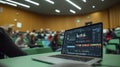 Laptop Displaying Data Graphs in a Lecture Hall Royalty Free Stock Photo