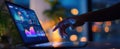 The laptop displaying dynamic data analytics during a night workspace session..AI generated image Royalty Free Stock Photo