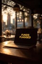 Laptop displaying funds flagged in a cafe Royalty Free Stock Photo