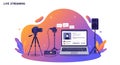 Laptop displaying a live streaming interface, positioned centrally. To the left, a camera Royalty Free Stock Photo