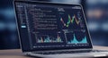 A laptop displays a dual-pane interface. On the left, colorful programming code is Royalty Free Stock Photo