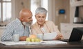 Laptop, document and senior couple in discussion at home for paying bills debt or mortgage online. Pension planning Royalty Free Stock Photo