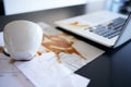 Laptop, documents and coffee spill, mistake or accident in empty office workplace interior. Computer, spilling tea and