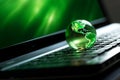laptop with earth globe on wooden table and green bokeh background Royalty Free Stock Photo
