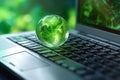 laptop with earth globe on wooden table and green bokeh background Royalty Free Stock Photo