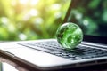 laptop with earth globe on wooden table and green bokeh background Royalty Free Stock Photo