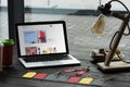laptop with ebay website on table with macarons coffee and sale tags