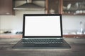 Laptop with empty blank screen on wooden tabletop with modern blur kitchen background