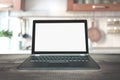 Laptop with empty blank screen on wooden tabletop with modern blur kitchen background