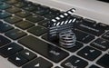 Laptop with films reel and movie clapper, Video editing or online movie internet concept 3d rendering Royalty Free Stock Photo