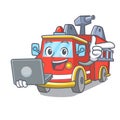 With laptop fire truck character cartoon Royalty Free Stock Photo