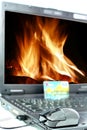 Laptop with flames on background Royalty Free Stock Photo