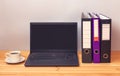 Laptop, folders and coffee cup on office desk Royalty Free Stock Photo