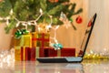 Laptop with gift box and christmas lights Royalty Free Stock Photo