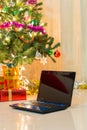 Laptop with gift box and christmas lights Royalty Free Stock Photo