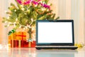 Laptop with gift box and christmas lights Royalty Free Stock Photo