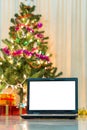 Laptop with gift box and christmas lights Royalty Free Stock Photo