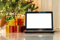 Laptop with gift box and christmas lights Royalty Free Stock Photo