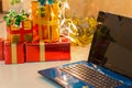 Laptop with gift box and christmas lights Royalty Free Stock Photo