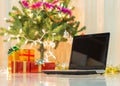 Laptop with gift box and christmas lights Royalty Free Stock Photo