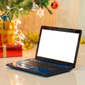 Laptop with gift box and christmas lights Royalty Free Stock Photo