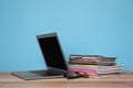 Laptop, glasses and stack of magazines on wooden table Royalty Free Stock Photo