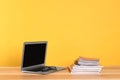 Laptop, glasses and stack of magazines on wooden table. Space for text Royalty Free Stock Photo