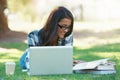 Laptop, grass or happy woman in park with books for learning knowledge, information or education. Smile, textbooks or Royalty Free Stock Photo