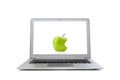 Laptop with green apple in screen isolated on white background Royalty Free Stock Photo