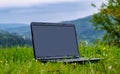 Laptop on green grass in park. Working outdoor concept Royalty Free Stock Photo