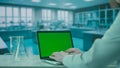 Laptop with Green Screen on Research Biochemistry lab Desk. Advertising area, workspace mock up. Royalty Free Stock Photo